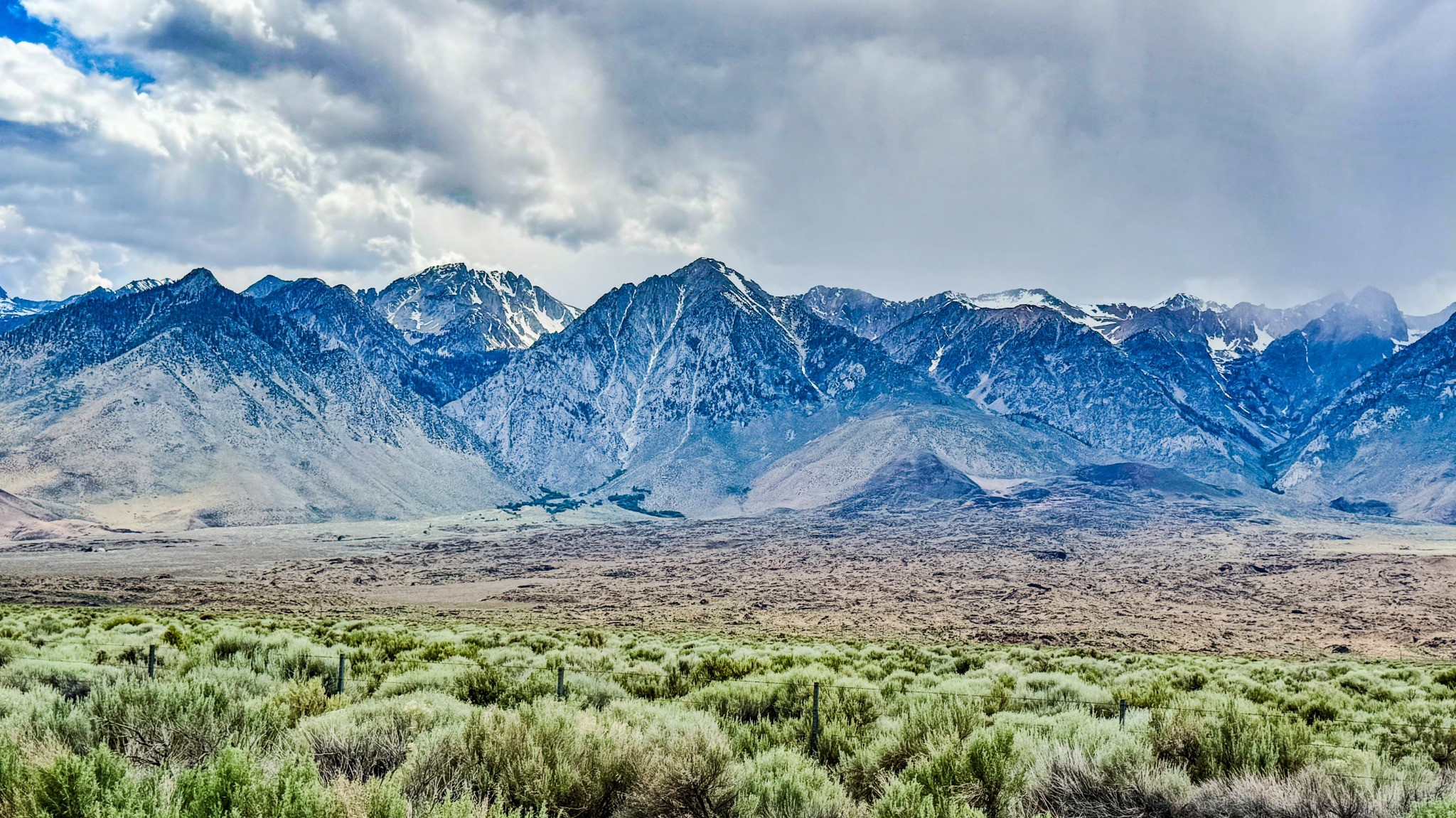 Dramatic mountain range beneath sweeping clouds